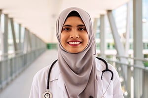 Doctor smiling in hospital skybridge
