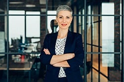 Woman in business attire smiling at camera